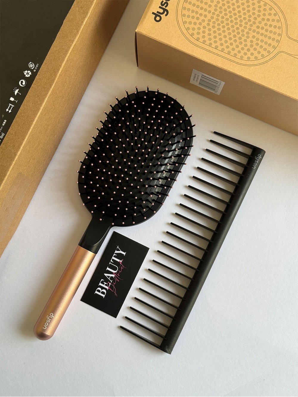 Dyson Black Paddle Brush with Rose Gold Handle and Black Wide-Tooth Comb